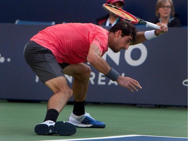 Thomaz Bellucci (BRA) struggles as he returns the ball to Novak Djokovic (SRB) during Rogers Cup action in Montreal on Tuesday August 11, 2015.