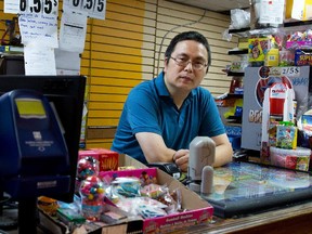 Xue Yong Qiao waits for a customer in his dépanneur in Montreal on Aug. 11, 2015.