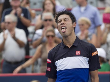 Kei Nishikori from Japan, pulls out his tongue after defeating Pablo Andujar from Spain, during Rogers Cup tennis action in Montreal on Wednesday August 12, 2015.