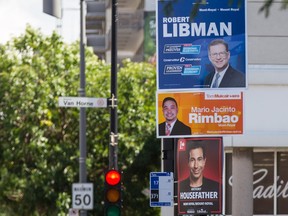 Top to bottom: Federal election campaign signs for candidates Robert Libman, with the Conservative Party, Mario Jacinto Rimbao, with the NDP, and Anthony Housefather, with the Liberal Party, on Décarie Boulevard in the riding of Mount-Royal in Montreal on Wednesday, August 12, 2015.