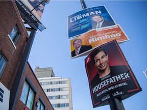 Top to bottom: Federal election campaign signs for candidates Robert Libman, with the Conservative Party, Mario Jacinto Rombao, with the NDP, and Anthony Housefather, with the Liberal Party, in the riding of Mount-Royal.