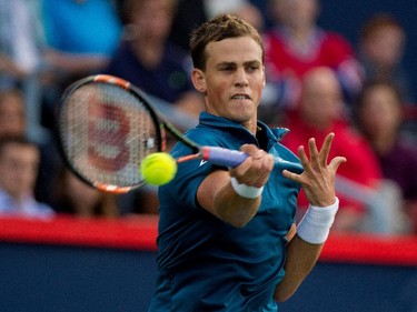Vasek Pospisil (CAN) returns the ball to John Isner (USA) during Rogers Cup action in Montreal on Wednesday August 12, 2015.