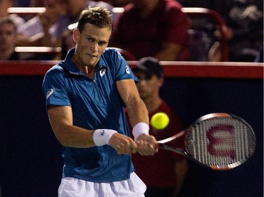 Vasek Pospisil (CAN) returns the ball to John Isner (USA) during Rogers Cup action in Montreal on Wednesday August 12, 2015.