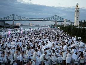 A sea of people dressed in white eat diner in the Old Port during the Dîner en Blanc on Thursday Aug. 13, 2015.