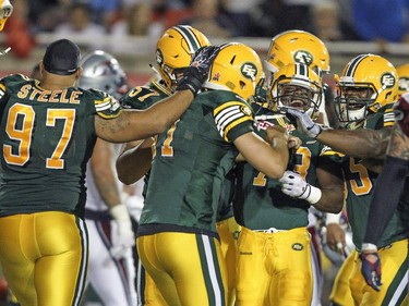 Edmonton Eskimos players celebrate with kicker Grant Shaw, back to the camera, after he kicked game winning field goal on the last play of Canadian Football League game against the Alouettes in Montreal Thursday August 13, 2015.