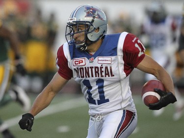 Montreal Alouettes Chip Cox runs upfield after intercepting pass by Edmonton Eskimos quarterback Matt Nichols during Canadian Football League game in Montreal Thursday August 13, 2015.