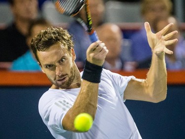 Ernests Gulbis of Latvia hits a return against Novak Djokovic of Serbia during their quarter-finals tennis match for the Roger's Cup Tennis Tournament at Uniprix Stadium in Montreal on Friday, August 14, 2015.