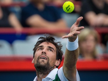 Jeremy Chardy of France makes a serve against John Isner of the United States during their quarter-finals tennis match for the Roger's Cup Tennis Tournament at Uniprix Stadium in Montreal on Friday, August 14, 2015.