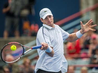 John Isner of the United States hits a return against Jeremy Chardy of France during their quarter-finals tennis match for the Roger's Cup Tennis Tournament at Uniprix Stadium in Montreal on Friday, August 14, 2015.