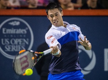 Kei Nishikori of Japan hits a return against Rafael Nadal of Spain during their quarter-finals tennis match for the Roger's Cup Tennis Tournament at Uniprix Stadium in Montreal on Friday, August 14, 2015.