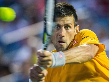 Novak Djokovic of Serbia hits a return against Ernests Gulbis of Latvia during their quarter-finals tennis match for the Roger's Cup Tennis Tournament at Uniprix Stadium in Montreal on Friday, August 14, 2015.