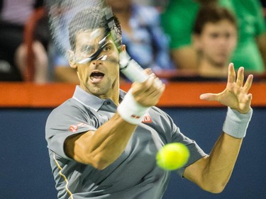 Novak Djokovic of Serbia hits a return against Ernests Gulbis of Latvia during their quarter-finals tennis match for the Roger's Cup Tennis Tournament at Uniprix Stadium in Montreal on Friday, August 14, 2015.