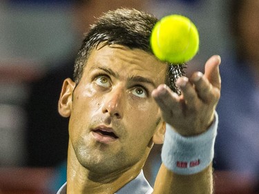 Novak Djokovic of Serbia makes a serve against Ernests Gulbis of Latvia during their quarter-finals tennis match for the Roger's Cup Tennis Tournament at Uniprix Stadium in Montreal on Friday, August 14, 2015.