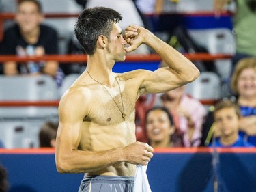 Novak Djokovic of Serbia playfully gestures during a break in his match against Ernests Gulbis of Latvia for the quarter-finals of the Roger's Cup Tennis Tournament at Uniprix Stadium in Montreal on Friday, August 14, 2015.