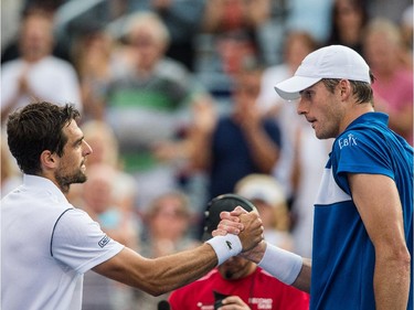 Winner Jeremy Chardy of France, left, shakes hands with John Isner of the United States, right, after beating him in their quarter-finals tennis match for the Roger's Cup Tennis Tournament at Uniprix Stadium in Montreal on Friday, August 14, 2015.