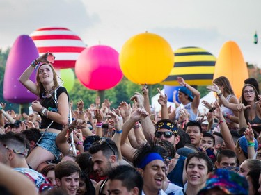 Music fans enjoy the performance by the Dutch DJ duo Showtek at the ÎleSoniq music festival at Jean-Drapeau Park in Montreal on Saturday, August 15, 2015.