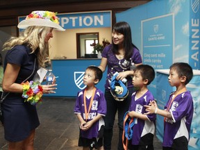 MONTREAL, QUE.: AUGUST 15,  2015 --  V¾©ronique Lemieux-Boyer, left, principal of  Sainte-Anne Academy, welcomes new students, three 6 1/2 yrs old triplets brothers, Joseph, Kevin and far right, Lawrence and their mother Xiaomei Zhang. Parents and students were invited at a BBQ and an open house organized by the Academie Sainte-Anne Academy.It is a new elementary school housed in the former Queen of Angels Academy building in Dorval.The private school offers kindergarten to Grade 6 instruction in both French and English. The school administration expected more than 600 people for that day. (Marie-France Coallier/ MONTREAL GAZETTE)