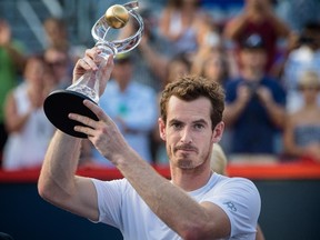 Andy Murray of Great Britain raises his trophy after defeating Novak Djokovic of Serbia in the men's final for the Rogers Cup Tennis Tournament at Uniprix Stadium in Montreal on Sunday, August 16, 2015.
