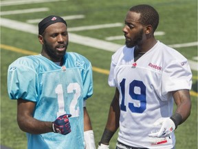 Alouettes quarterback Rakeem Cato (left) and slotback S.J. Green talk at practice at Parc Hébert de Saint-Léonard in Montreal Monday, Aug. 17, 2015.