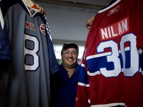 Serge Deuvletian, a Montreal veterinarian with Asperger Syndrome, poses with some of his sports memorabilia on Aug. 17, 2015.