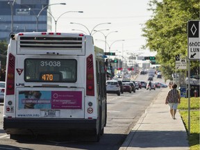 An STM bus drives southbound on St. Jean Blvd. on the reserved bus lane in Dollard-des-Ormeaux.