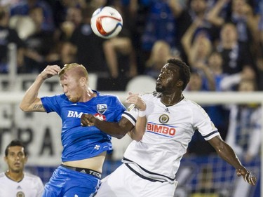Calum Mallace of the Montreal Impact (left) and C.J. Sapong of the Philadelphia Union fight for a ball in the first half of an M.L.S. game at Saputo Stadium in Montreal Saturday, August 22, 2015.