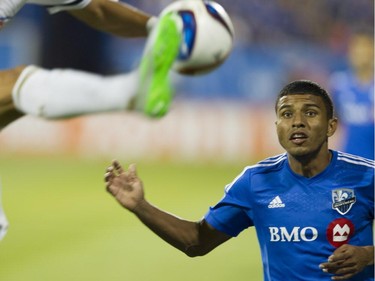 Johan Venegas of the Montreal Impact (right) keeps his eye on the ball as Steven Vitoria of the Philadelphia Union kicks it in the first half of an M.L.S. game at Saputo Stadium in Montreal Saturday, August 22, 2015.