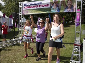 Participants cross the finish line at the Weekend to End Women's Cancer, where participants walked 60 kilometres Sunday August 23, 2015, to raise funds for the Jewish General Hospital's Cancer Centre in Montreal.