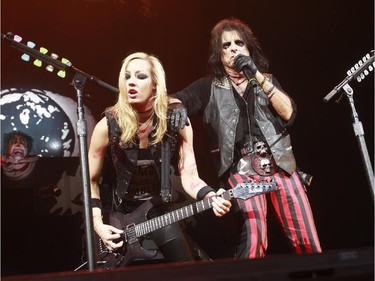 Alice Cooper, right, performs with guitarist Nita Strauss, left, during a concert at the Bell Centre in Montreal, Monday August 24, 2015.