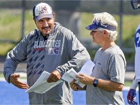 MONTREAL, QUE.: August 24, 2015 -- Montreal Alouettes head coach and general manager Jim Popp, right, listens to  quarterbacks coach Anthony Calvillo during practice in Montreal Monday August 24, 2015. (John Mahoney / MONTREAL GAZETTE)