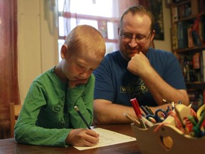 David McLeod supervises seven-year-old son Callum’s homework session. McLeod, a former junior high school teacher, sees the value in homework but wonders: “Should kids be resting their brains and come back fresh in the morning?”