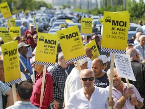 Protesting taxi drivers block Marc Cantin St. in the Techno-Parc in Montreal, Tuesday August 25, 2015.  The drivers are unhappy with UberX and other alternate travel options operating in Montreal.