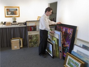 Michael Millman packs up paintings at his West End Gallery in Westmount, Wednesday Aug. 26, 2015.