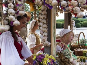 (Left to right) Emilie Gagne, Richard Behm, Elizabeth Lachapelle, Carly Elliott, from Bionicale Farm are seen in their garlic flower product display at the Pointe-à-Callière public market, a recreation of Montreal's 18th century outdoor market, in Old Port in Montreal on Saturday, Aug. 28, 2010.
