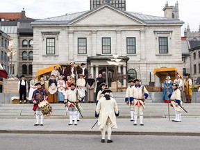 People dressed in 18th century clothes take part in a parade at the Pointe-à-Callière public market, a recreation of Montreal's 18th century outdoor market, in Old Port in Montreal.