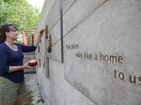 Artist Lalie Douglas puts the finishing touches on a mural, unveiled on Tuesday in front of the MAB-Mackay Rehabilitation Centre, that honours Thomas Widd.