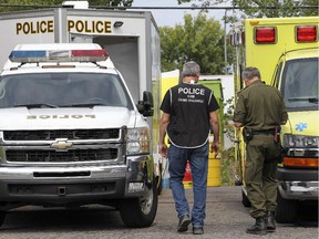 Police investigators work outside a warehouse suspected of being a drug lab used for manufacturing fentanyl in Dorval west of Montreal Saturday August 29, 2015.