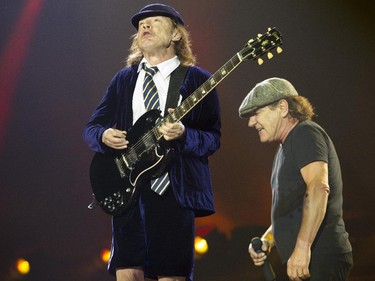 Guitarist Angus Young of the Australian hard rock band AC/DC performs at the Olympic Stadium in Montreal Monday, August 31, 2015 as singer Brian Johnson walks by behind. The rockers AC/DC were back in town in support of last year's Rock or Bust album.