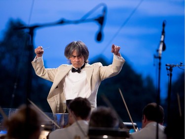 Kent Nagano conducts the Orchestre symphonique de Montréal as they play excerpts from Bizet's Carmen in a free outdoor show on the esplanade of the Olympic Park in Montreal on Wednesday August 5, 2015.