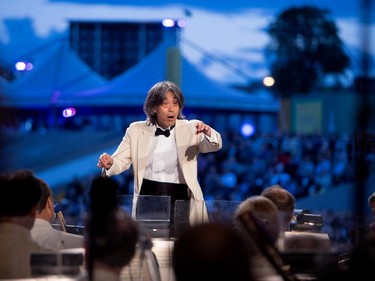 Kent Nagano conducts the Orchestre symphonique de Montréal as they play excerpts from Bizet's Carmen in a free outdoor show on the esplanade of the Olympic Park in Montreal on Wednesday August 5, 2015.