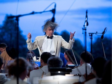 Kent Nagano conducts the Orchestre symphonique de Montréal as they play excerpts from Bizet's Carmen in a free outdoor show on the esplanade of the Olympic Park in Montreal on Wednesday August 5, 2015.
