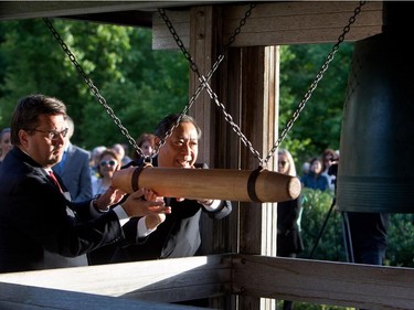 Montreal mayor Denis Coderre, left, and Hideaki Kuramitsu, Consul General of Japan, ring the Peace bell in the Montreal Botanical Gardens on Wednesday August 5, 2015.