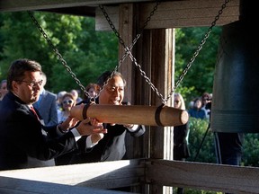 Montreal mayor Denis Coderre, left, and Hideaki Kuramitsu, Consul General of Japan, ring the Peace bell in the Montreal Botanical Gardens on Wednesday August 5, 2015. The bell is rung each year to mark the exact moment the world‚Äôs first nuclear bomb was dropped on a city, Hiroshima, on August 6th 1945.