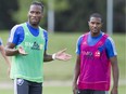 New Impact player Didier Drogba (left) talks with teammate Patrice Bernier during practice at the team's Montreal training facility on Aug. 6, 2015.