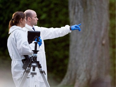 Sureté du Québec police investigators speak as they search the home of Cheryl Bau-Tremblay after her body was found inside the Beloeil home near Montreal on Thursday August 6, 2015.