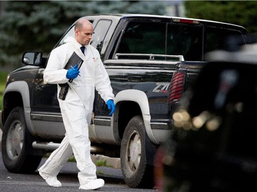 Sureté du Québec police search the home of Cheryl Bau-Tremblay after her body was found inside the Beloeil home near Montreal on Thursday August 6, 2015.