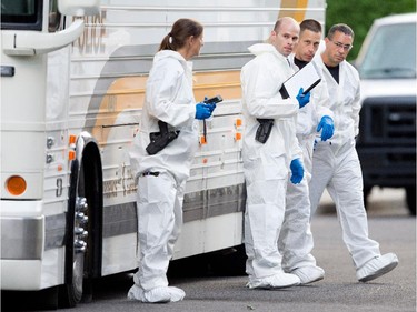 Sureté du Québec police speak after taking a short break from searching the home of Cheryl Bau-Tremblay after her body was found inside the Beloeil home near Montreal on Thursday August 6, 2015.