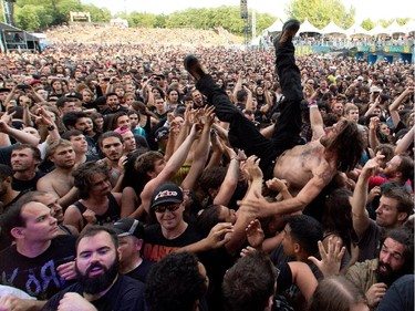 A fan body surfs as Meshuggah performs at Heavy Metal Montreal at Parc Jean-Drapeau in Montreal on Friday August 7, 2015.