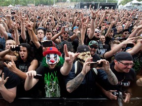 Fans cheer as Arch Enemy takes the stage at Heavy Montréal at Parc Jean-Drapeau in Montreal on Friday August 7, 2015.