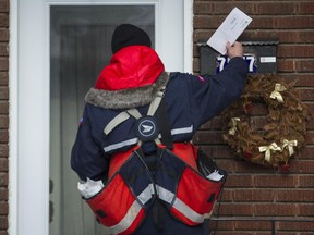 A Canada Post mailman delivers mail.